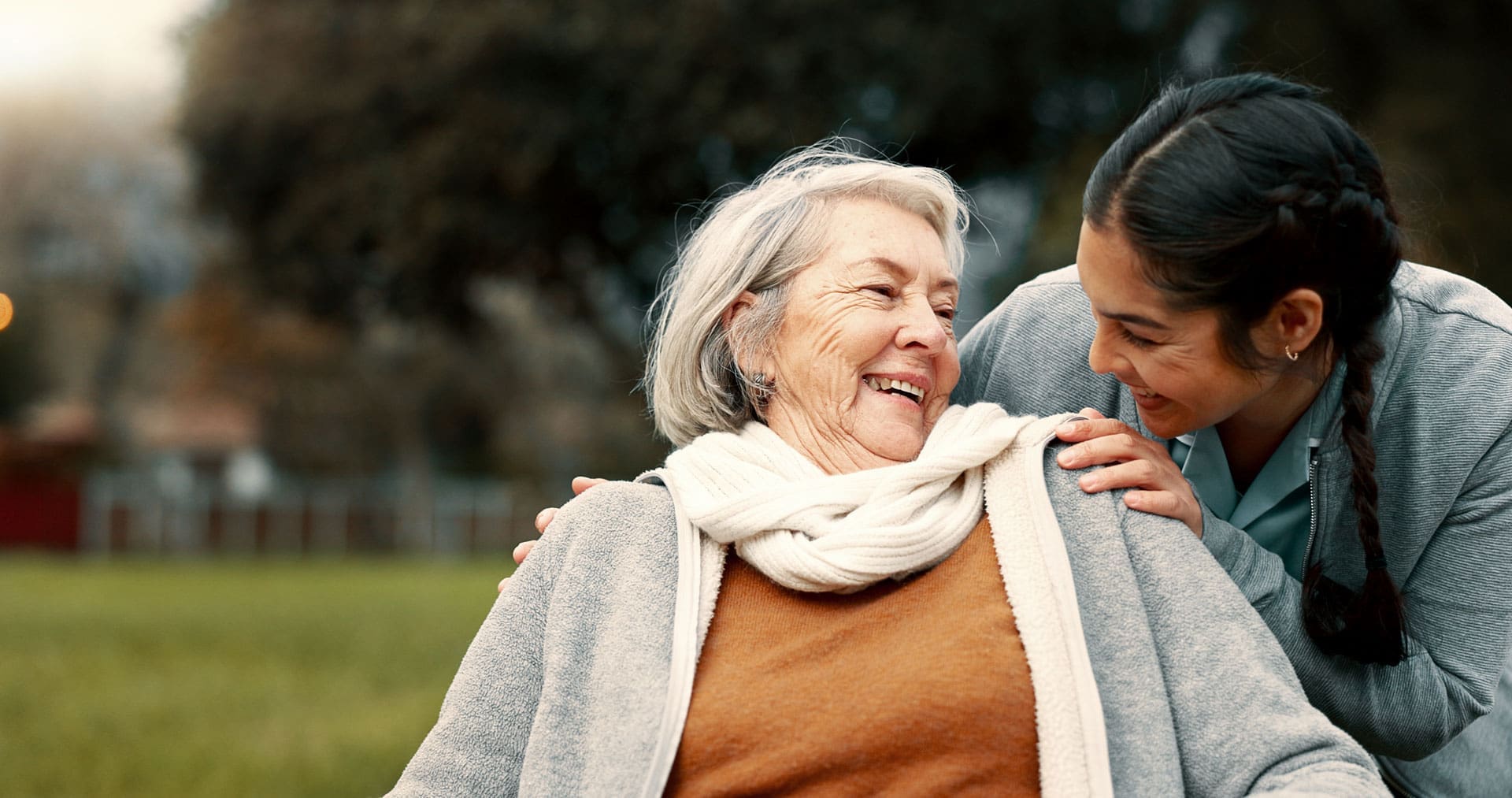 Caregiver helping woman with disability in park for support, trust and care in retirement