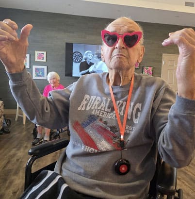 senior with pink glasses