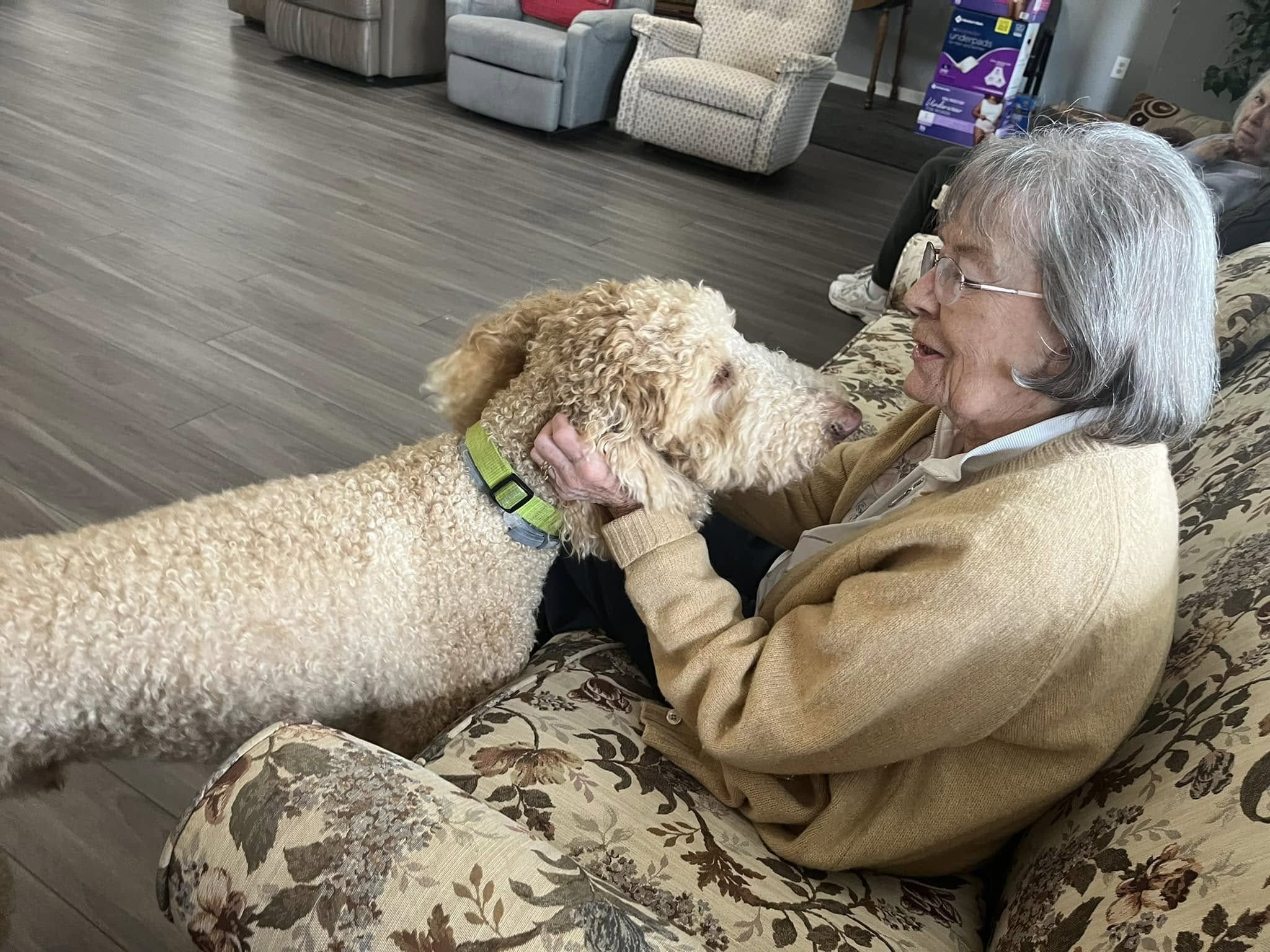 A woman petting a dog.